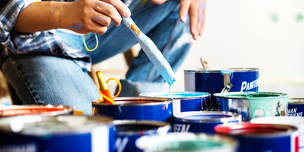 Contractor mixing paints to paint client's house