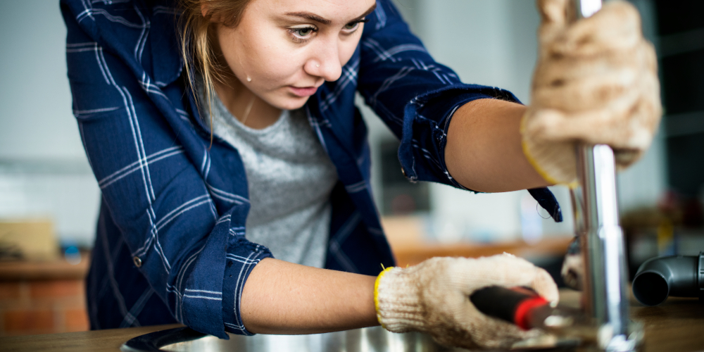 Woman replacing a worn out O-ring seal of a leaking faucet